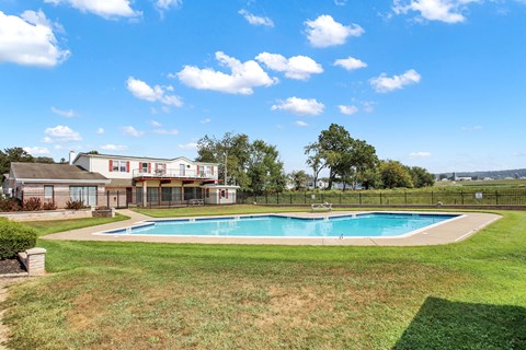 A large house with a pool in the backyard.