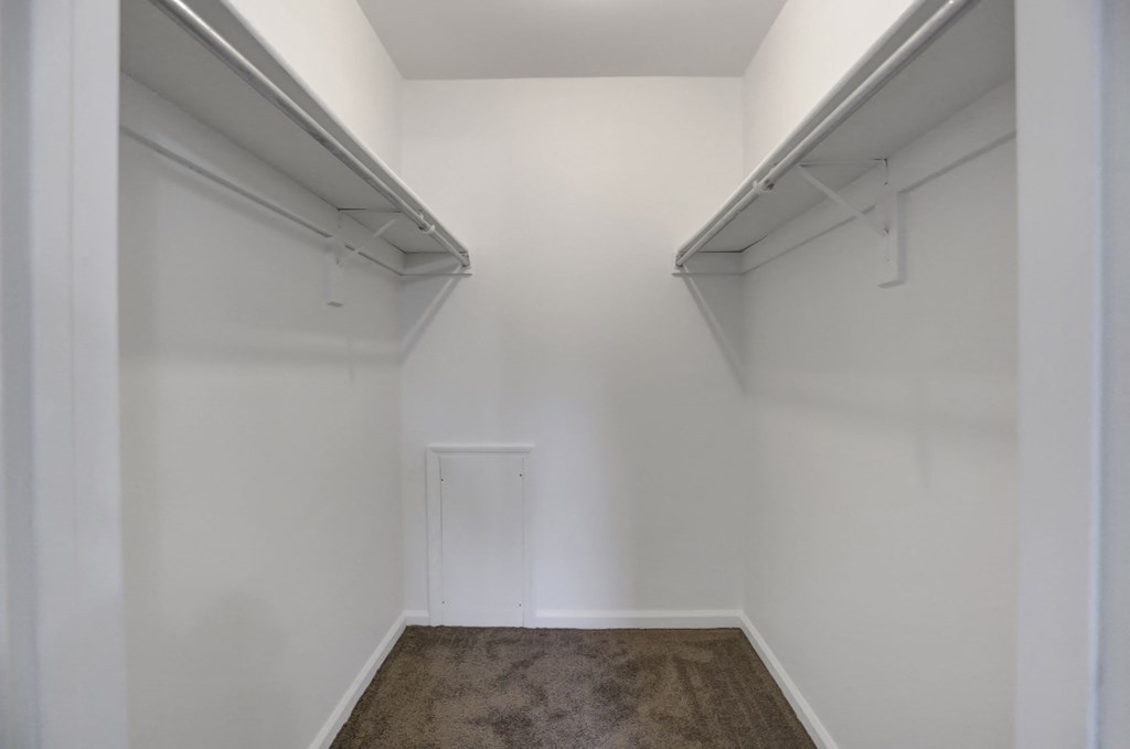 a empty room with white walls and a carpet