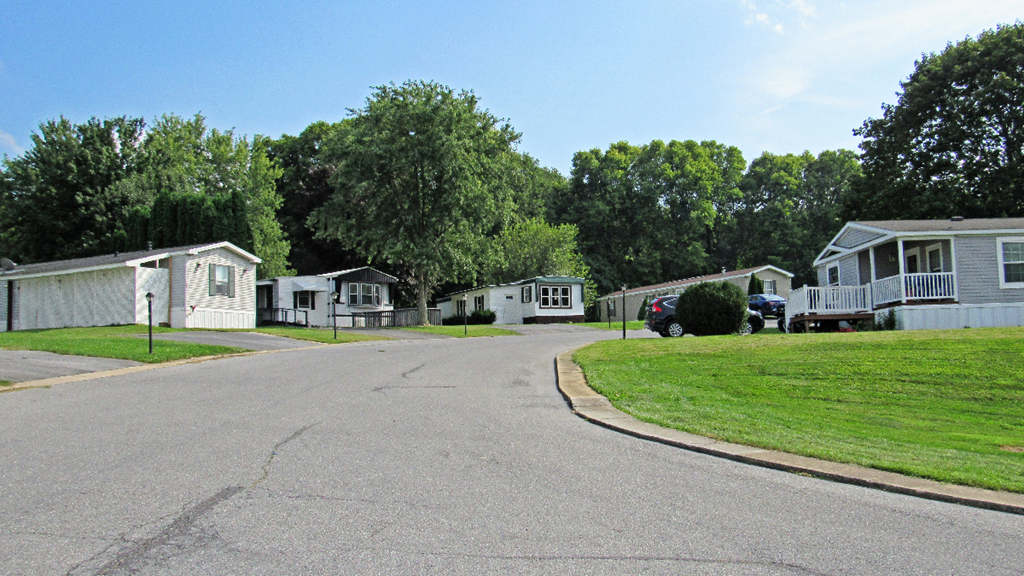 an empty street with houses on both sides of it