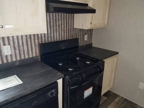 A black stove top oven with a paper on the counter.