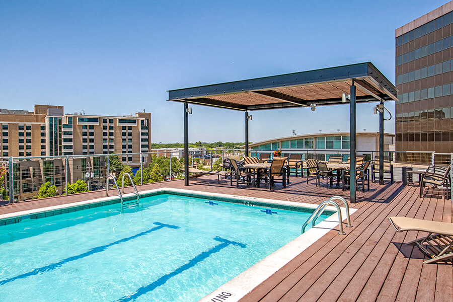 Olympic style swimming pool with cabana, sun loungers, picnic tables