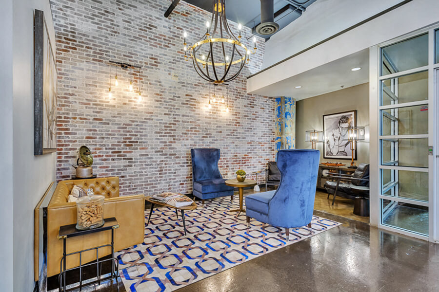 Leasing office, cozy lounge area with beautiful brick wall
