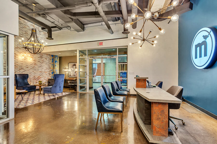 leasing office with concrete floor, and brick wall