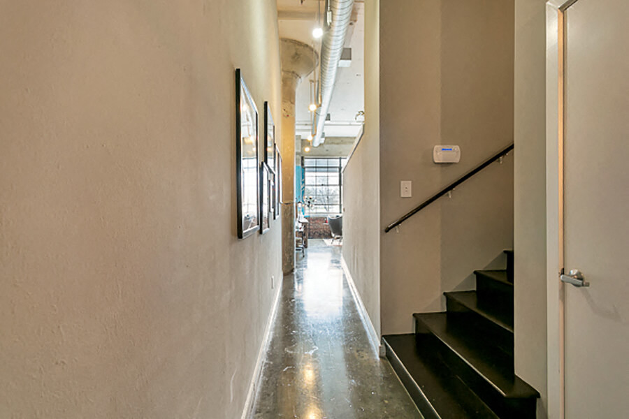 Long hallway with concrete flooring