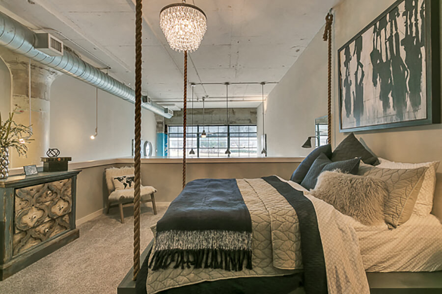 Large bedroom with carpet. Loft style