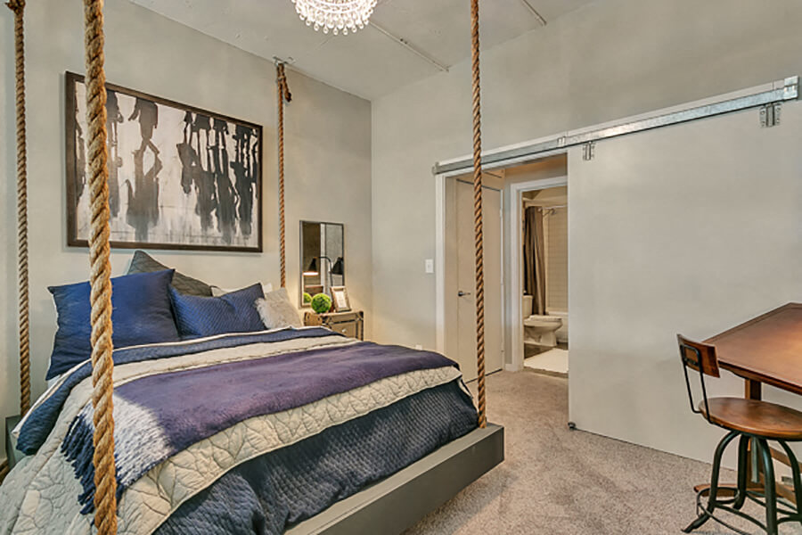 Large bedroom with carpet and barn door