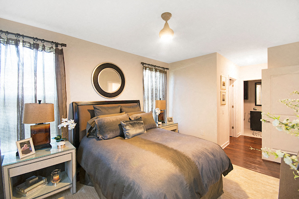 a bedroom with a bed and a mirror