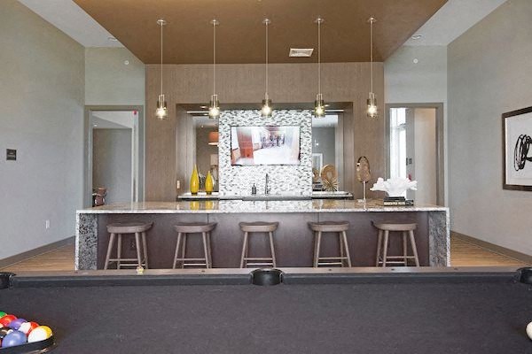 a kitchen with a bar and some stools
