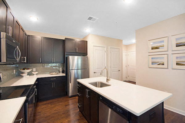 a kitchen with stainless steel appliances and white counter tops