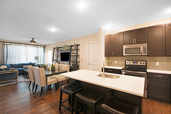 a kitchen and living room with a table and chairs