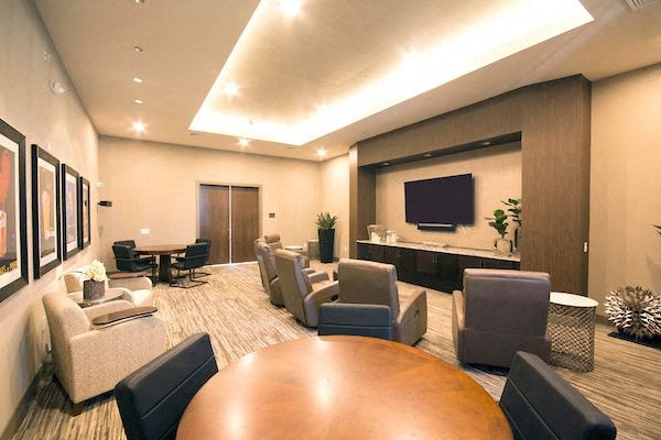 a large living room with chairs and a table