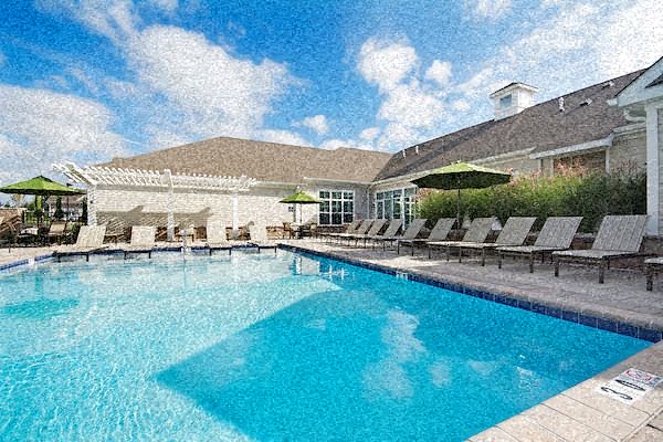 a large swimming pool with chairs and umbrellas