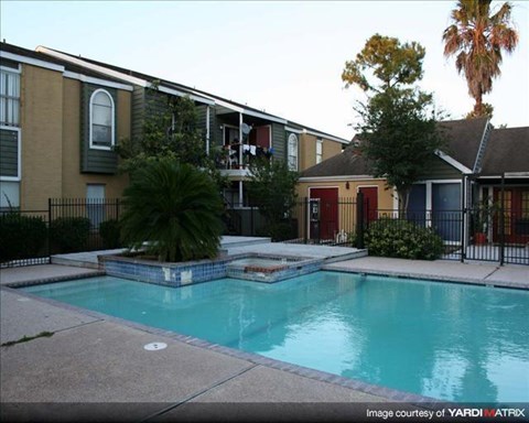 a swimming pool in front of an apartment building
