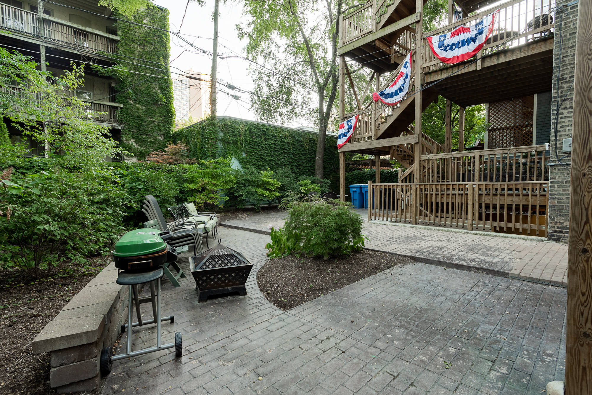 a patio with a table and chairs and a grill