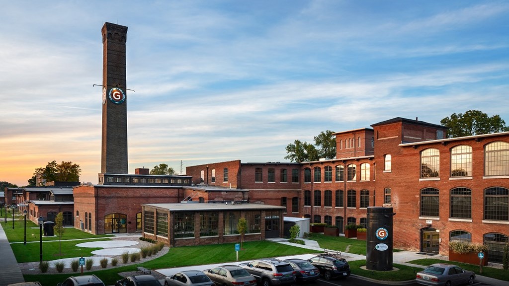 a parking lot in front of a building with a clock tower