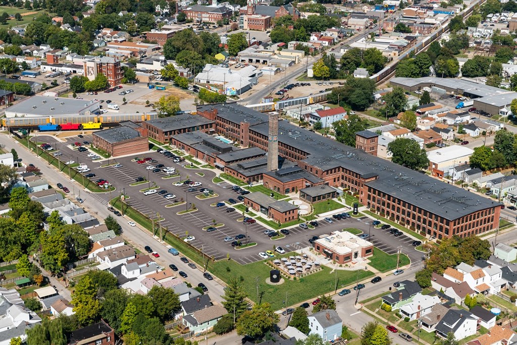 an aerial view of a city with a parking lot and buildings