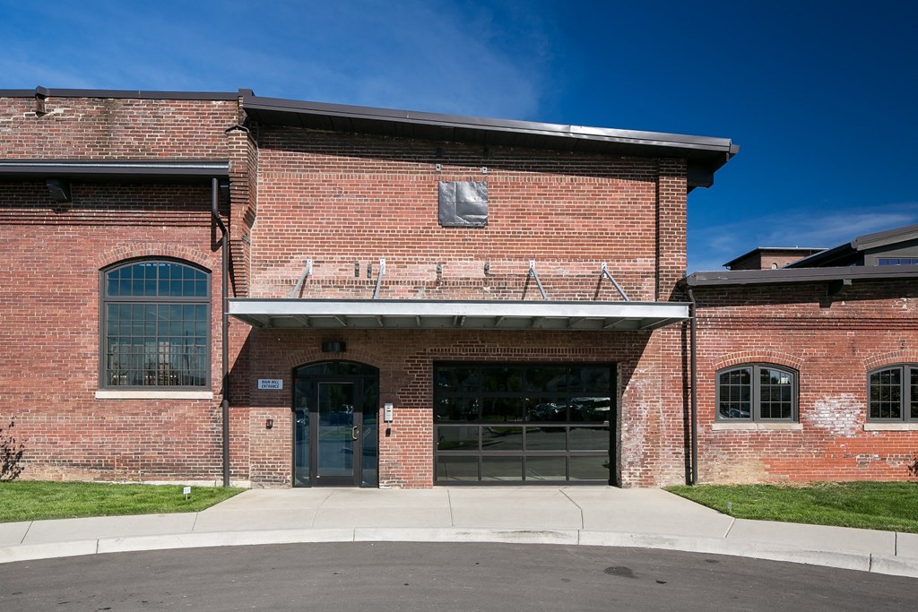 the front of a brick building with a glass door