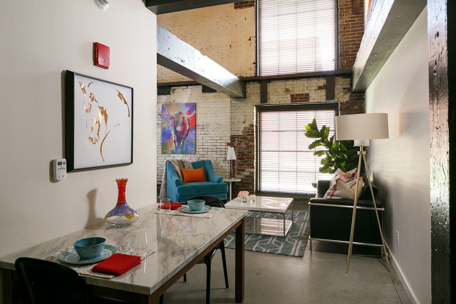 a dining room with a table and chairs and a living room