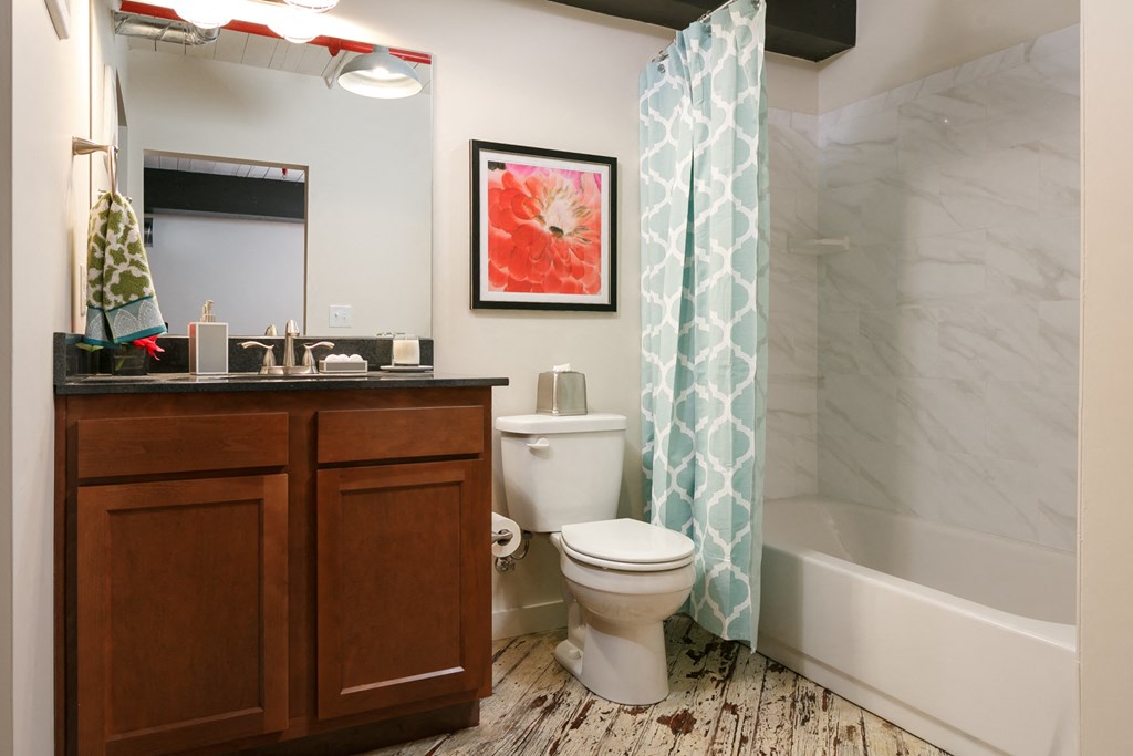 a bathroom with a toilet and a shower and a sink