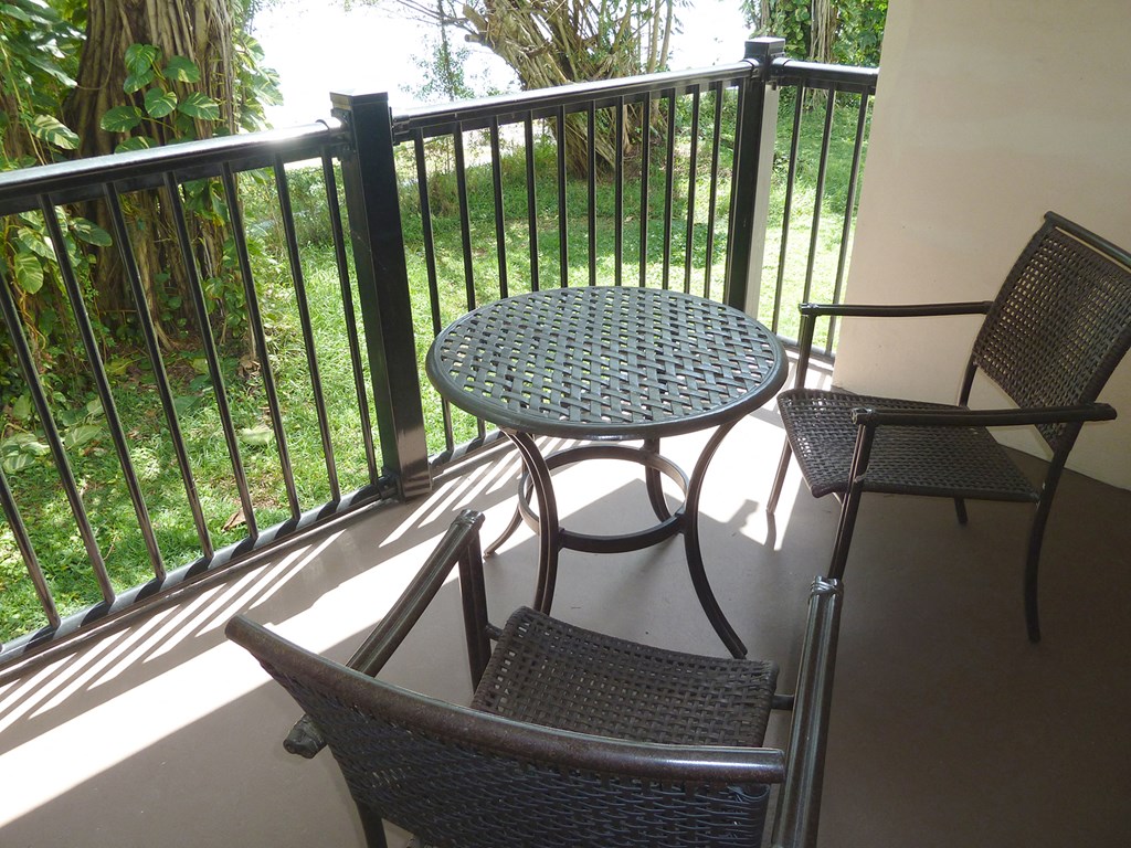 a patio with a table and chairs on a balcony