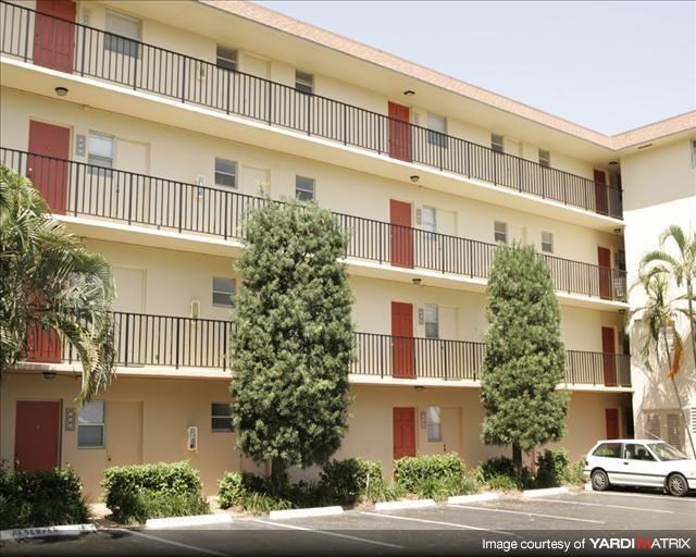 an apartment building with a car parked in front of it