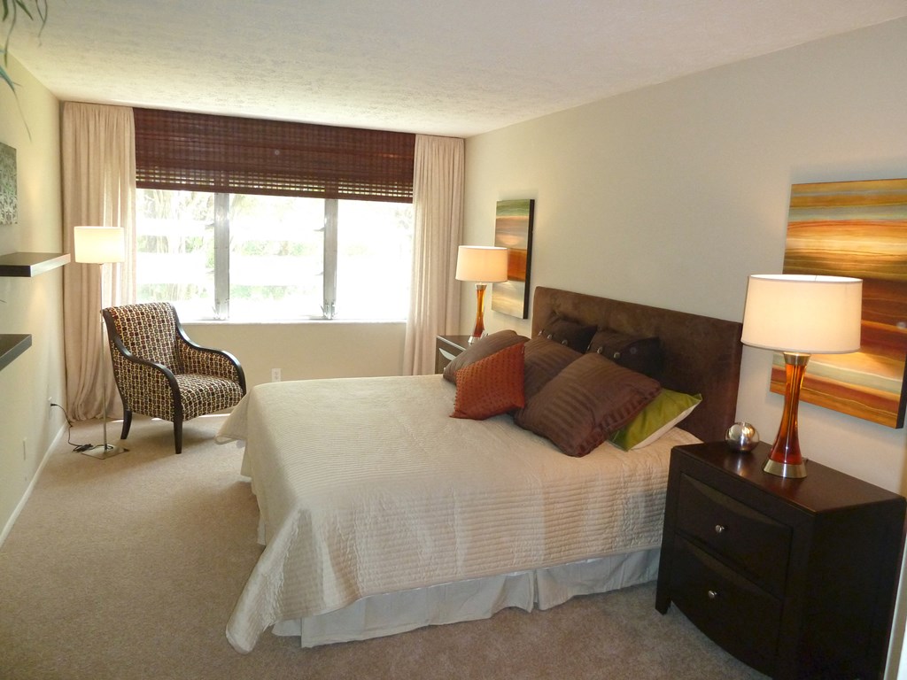 a bedroom with a large bed and a window