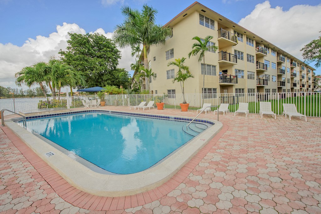 a swimming pool with a building in the background
