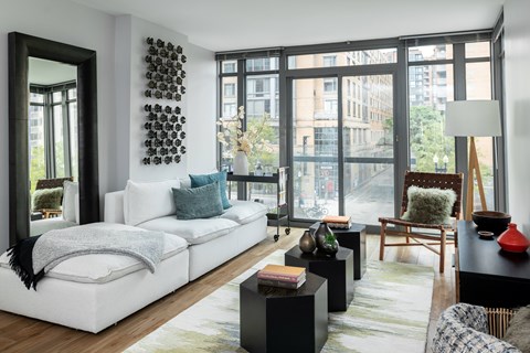 A modern living room with a white sofa and a black coffee table.