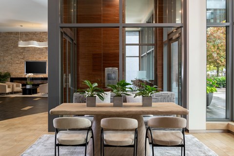 A modern dining room with a wooden table and chairs.