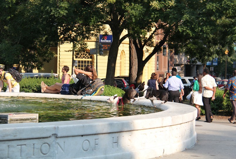 a group of people are laying in a fountain