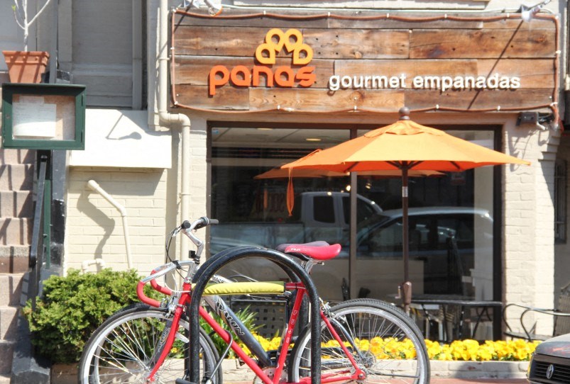 a bike parked in front of a panda gourmet emporium