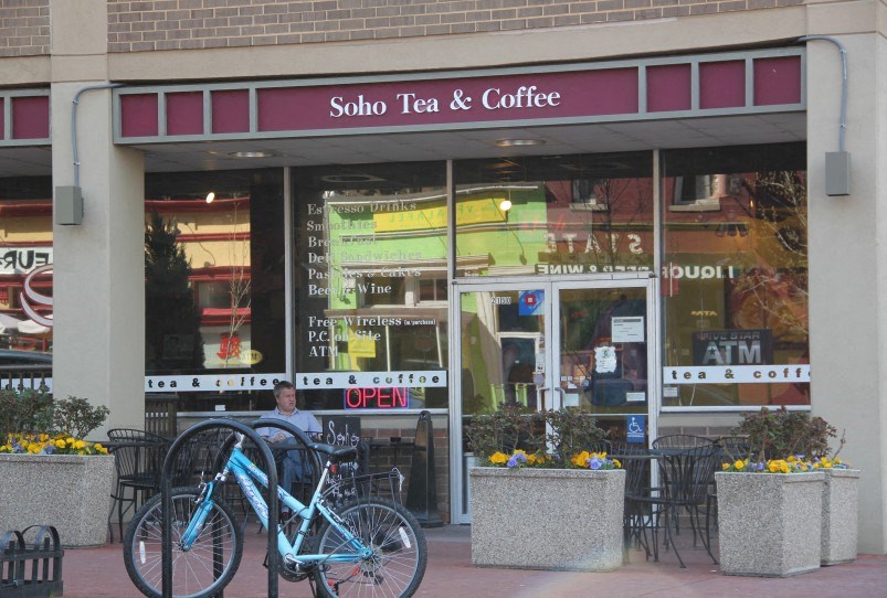 a blue bike parked in front of a coffee shop