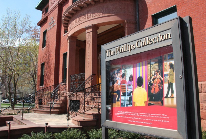a sign outside the philly collection in front of a building