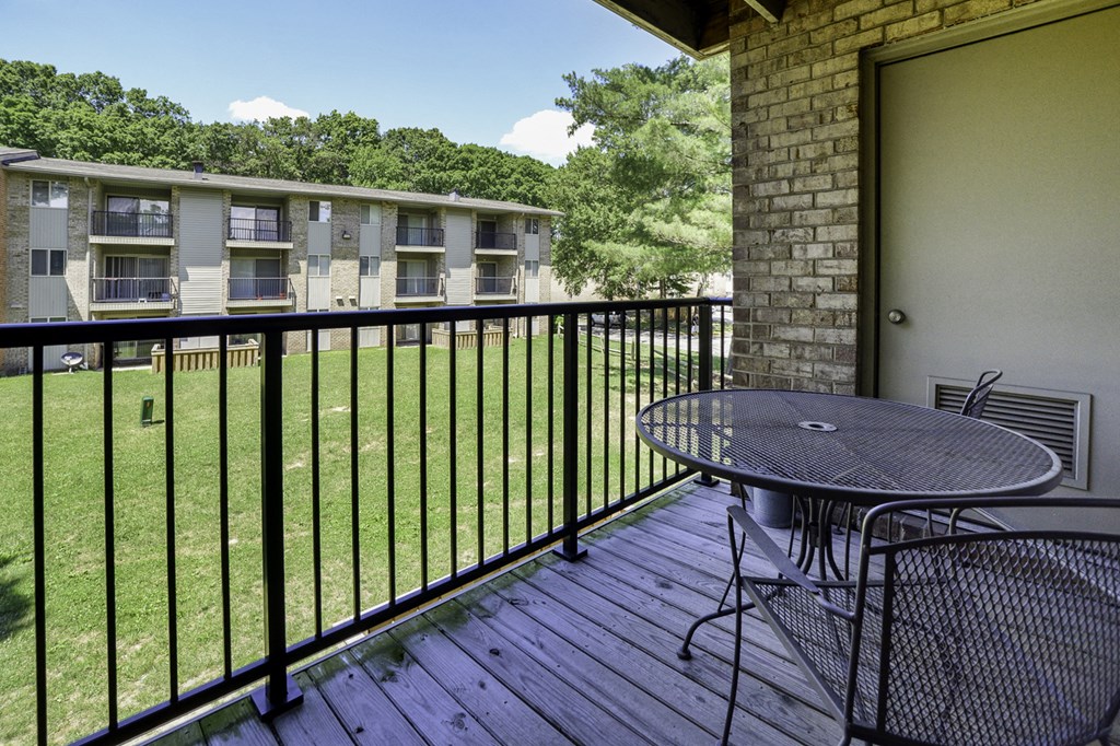 a patio with a table and chairs on a balcony