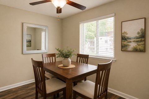 A dining room with a wooden table and chairs.