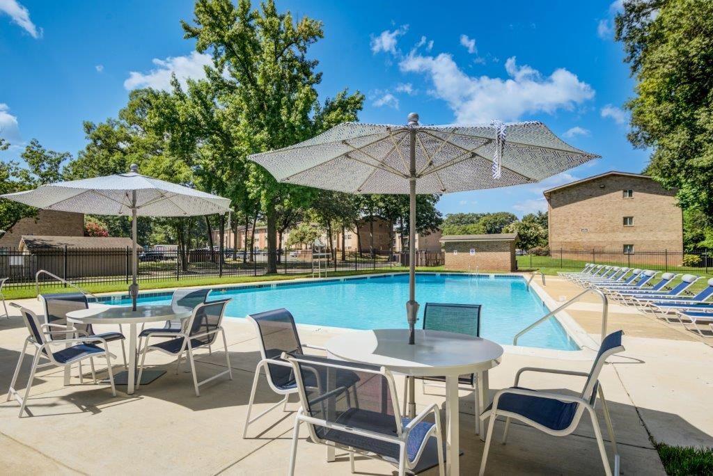 our apartments have a resort style pool with tables and chairs
