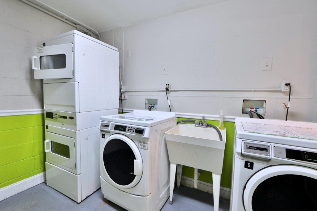 a laundry room with washing machines and a sink