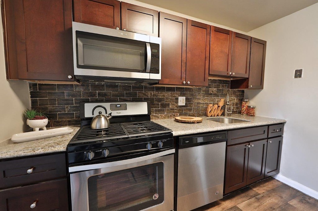 a kitchen with stainless steel appliances and wooden cabinets
