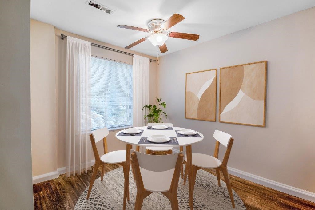 a dining room with a table and chairs and a ceiling fan