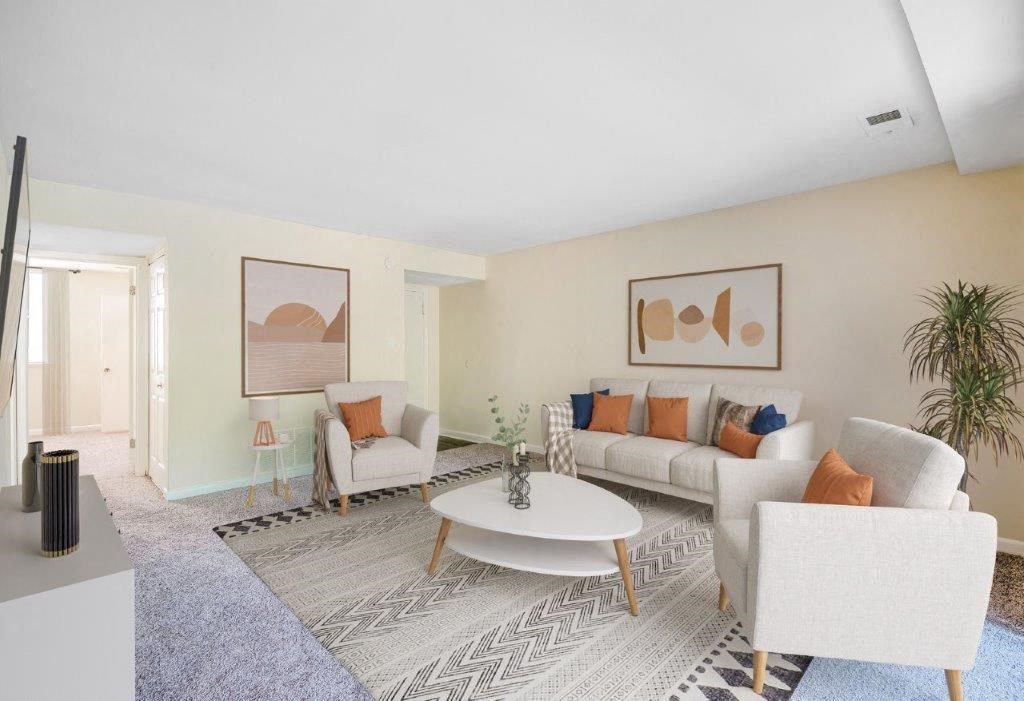 a living room with couches and chairs and a table