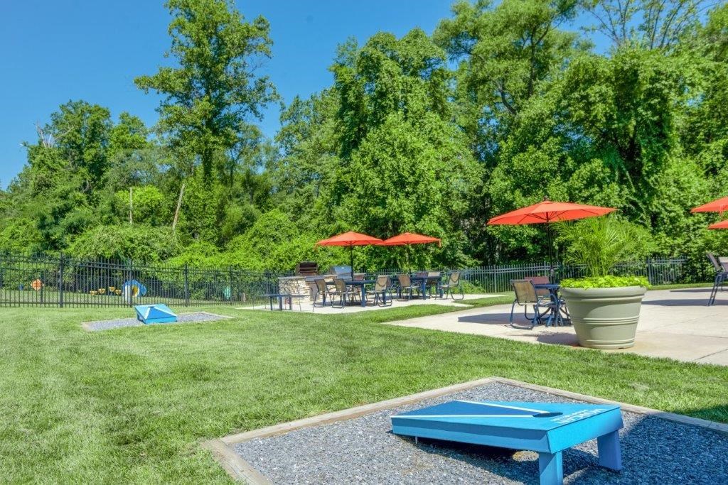 a picnic area with tables and umbrellas in a park