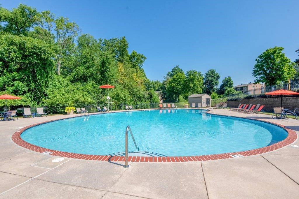 a swimming pool with umbrellas and chairs around it