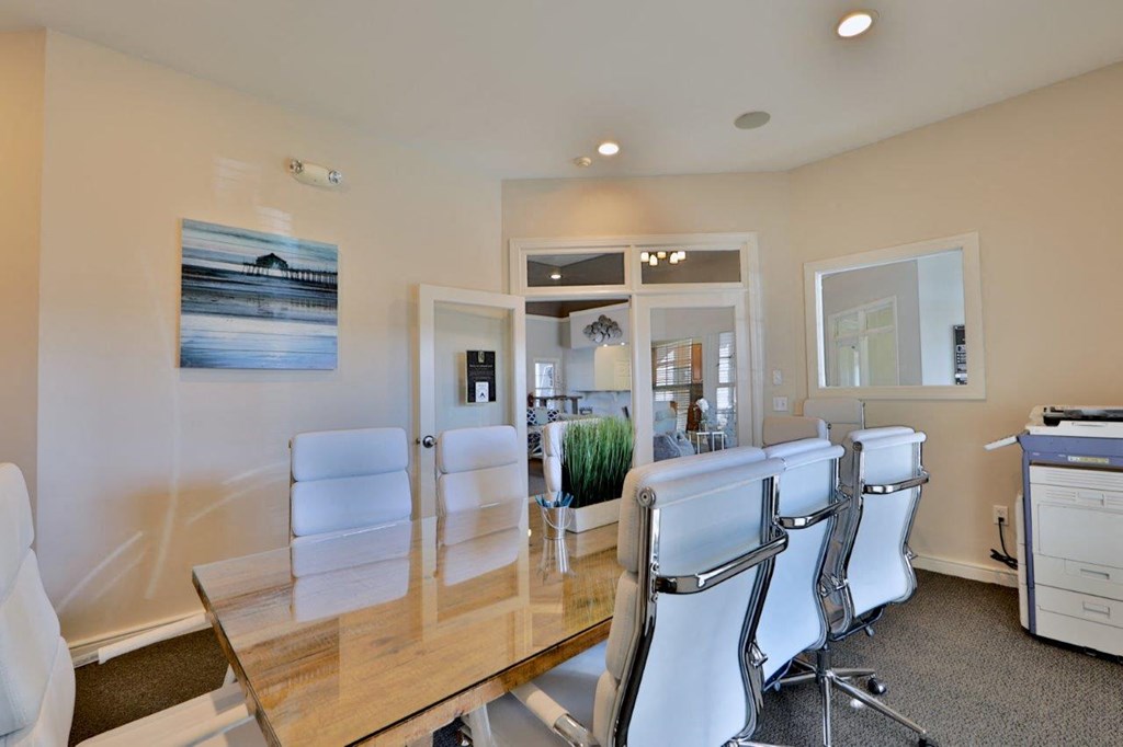 a conference room with a wooden table and chairs