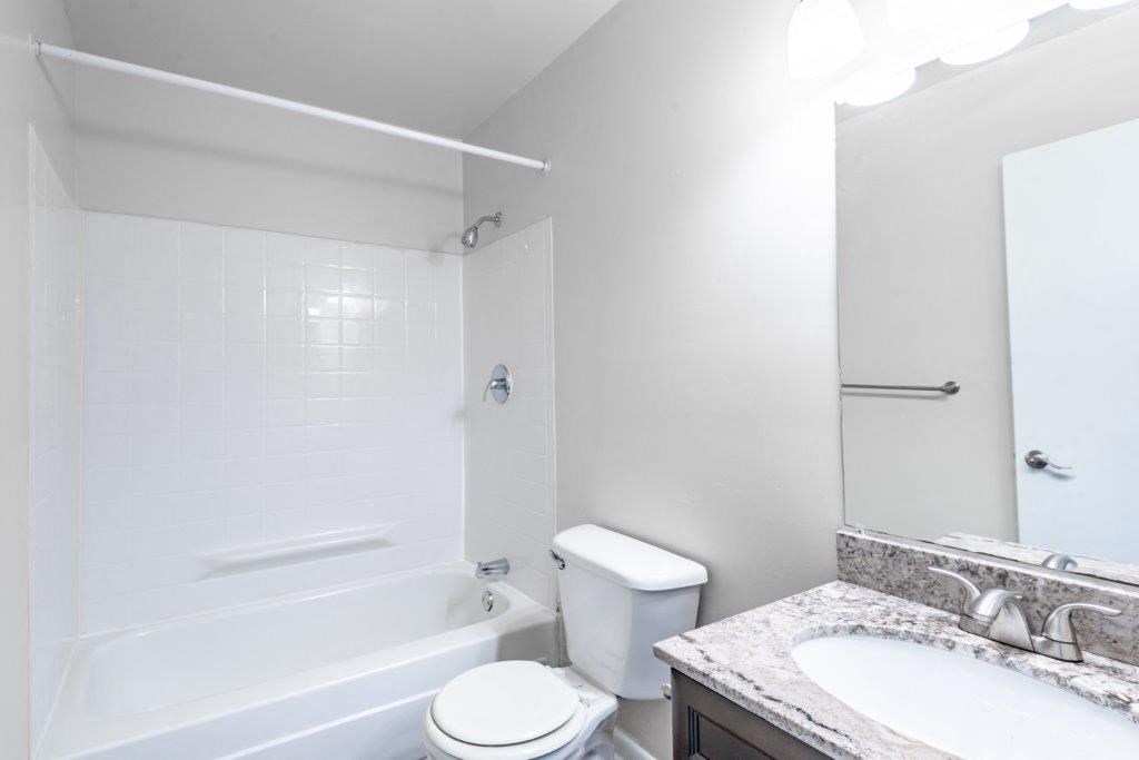 a bathroom with a sink toilet and a bath tub