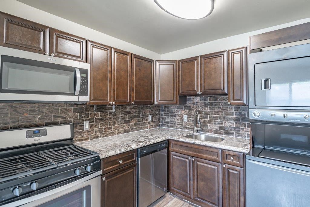 a kitchen with stainless steel appliances and wooden cabinets