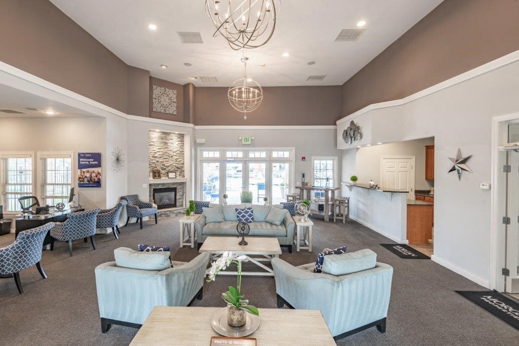 a living room with couches and chairs and a fireplace