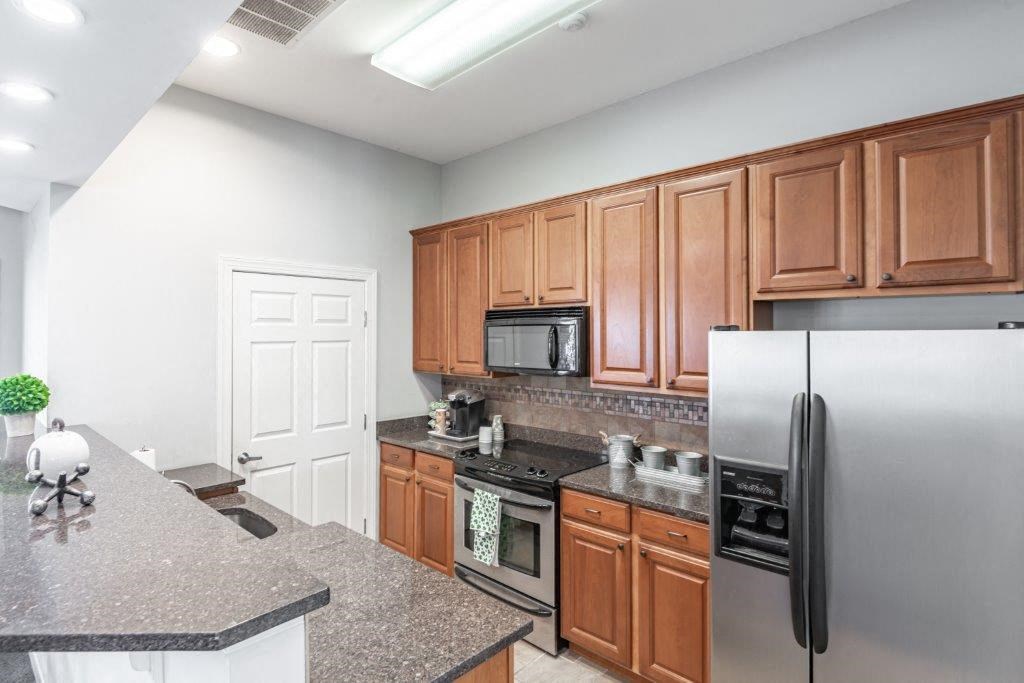 a kitchen with stainless steel appliances and granite counter tops