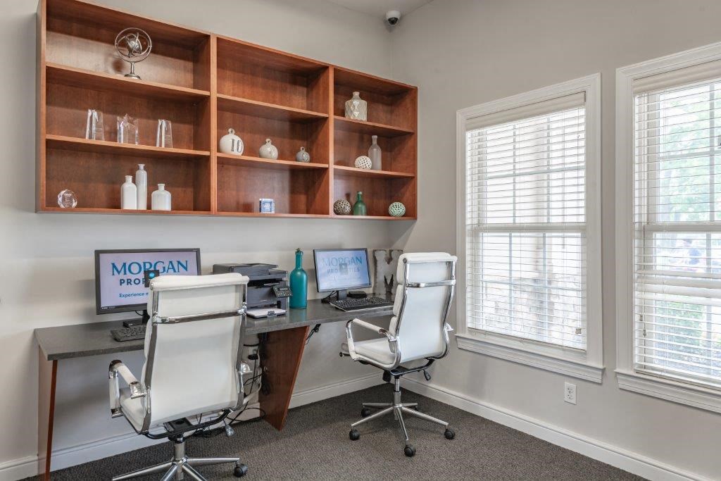 a home office with two chairs and a desk with a computer