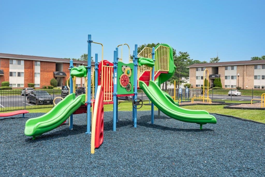 a playground with slides at an apartment complex