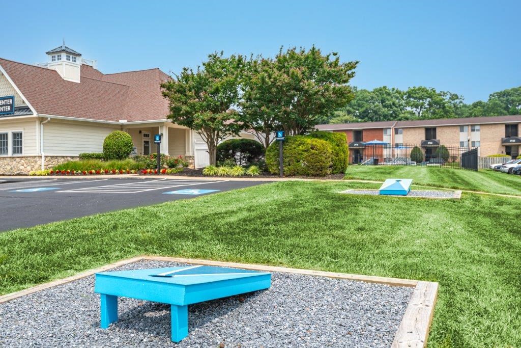 a blue picnic table in front of a parking lot